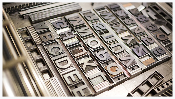 Old typography printing machine with font characters for craftman typography